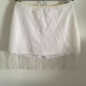 White lace mini skort with fringe trim.